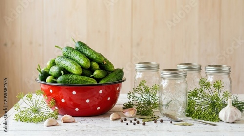 Fresh Cucumbers and Pickling Ingredients Ready for Preservation in Glass Jars