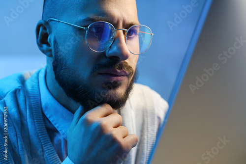 Thoughtful male trader with...