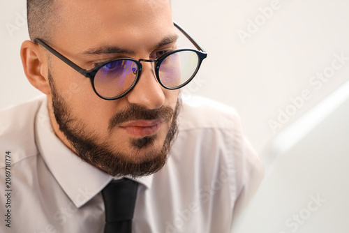 Male trader in eyeglasses w...