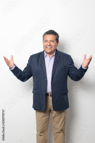 60-year-old Latino man with dark skin appears happy and at peace, enjoying a successful professional and personal life