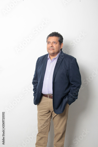 60-year-old Latino man with dark skin appears happy and at peace, enjoying a successful professional and personal life