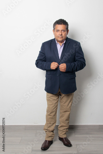 60-year-old Latino man with dark skin appears happy and at peace, enjoying a successful professional and personal life