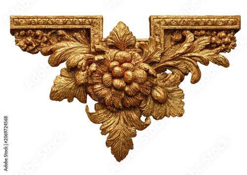 Ornate golden floral carved relief against a black background