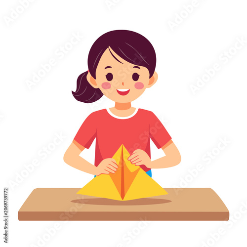 Girl folding yellow origami paper at table