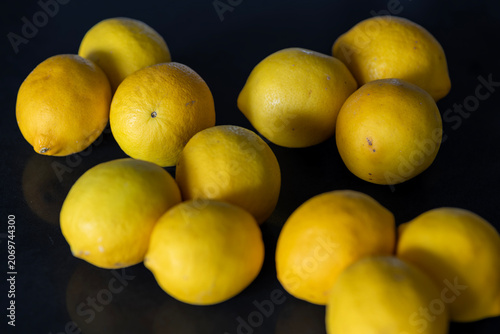 Fresh Yellow Lemons on Dark Surface with Selective Focus