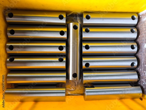 Metal CNC Rods in Yellow Container