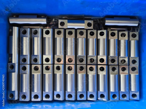 Metal CNC Parts in a Blue Container