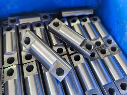 Metal CNC Parts in a Blue Container