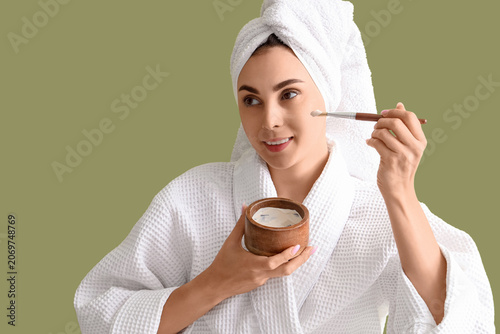 Young woman in bathrobe app...