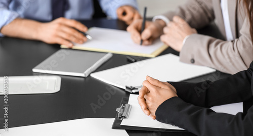 Obraz na plátně Court mediator working with clients at table in office, closeup