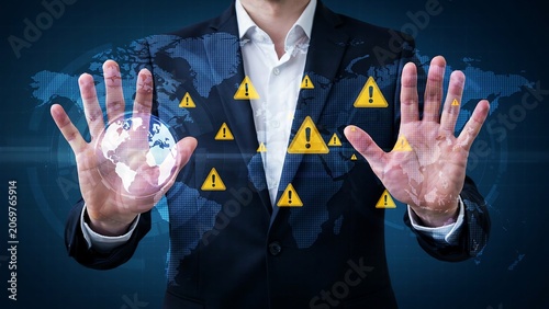 Businessman displaying world map with global risk warning signs and earth projection demonstrating international business.