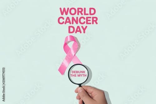 World Cancer Day concept with pink ribbon and magnifying glass
