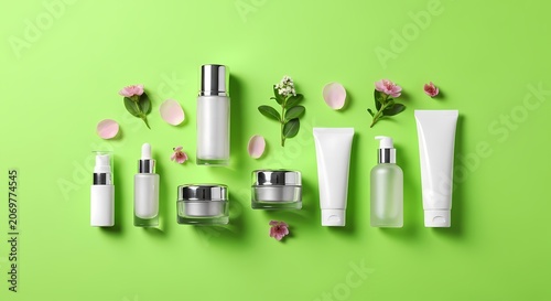 Luxury Skincare Products with Delicate Flowers on Vibrant Green Background