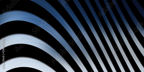 Modern architectural curves under a clear blue sky