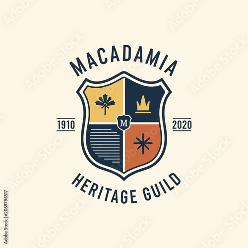 Obraz na plátně Macadamia heritage guild heraldic shield logo with nut and crown icons in a crest