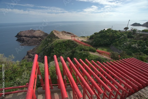 Red bridge over rocky coast from above in summer, Japan