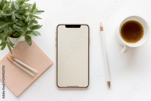 A plan for a clean workspace layout with a smartphone and a coffee cup.