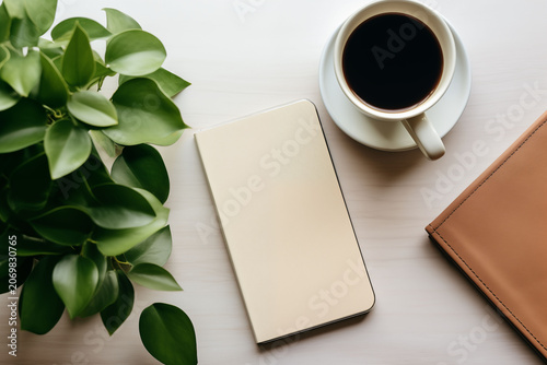 A plan for a clean workspace layout with a smartphone and a coffee cup.