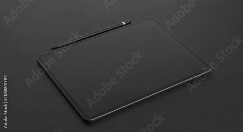Black tablet with stylus on surface.