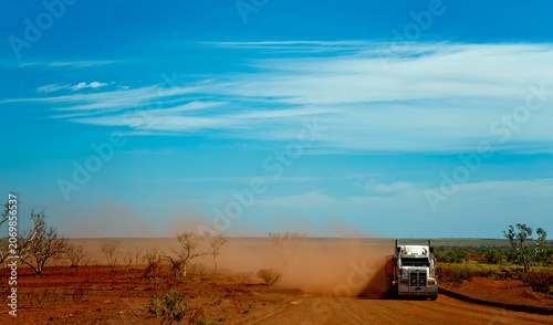 Foto Road truck raising dust on remote outback road in Australia