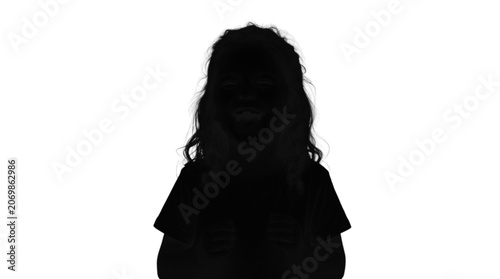Silhouette of a child looking down with curly hair