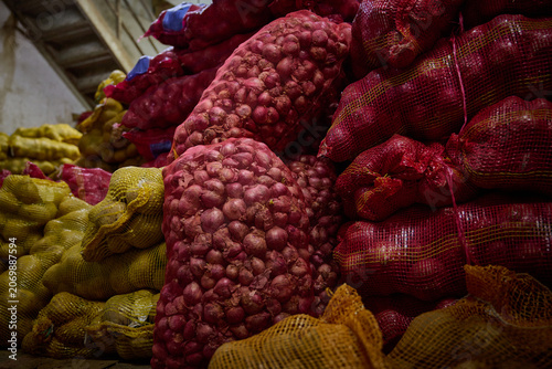 Sacks of Red Onions Stacked in Wholesale Produce Warehouse