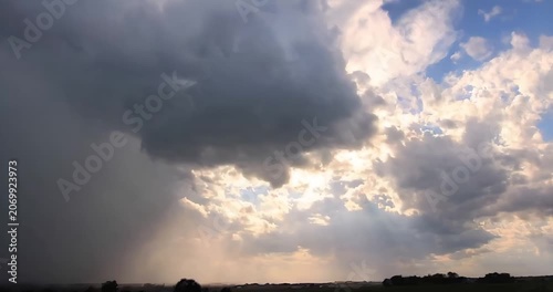Massive storm clouds forming before heavy rain in dramatic sky
