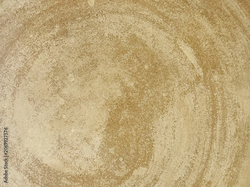 Abstract brown concrete wall texture background with rough spiral brush strokes effect.