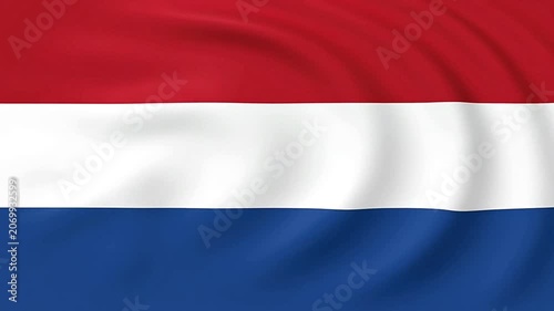 A close-up shot of a red, white, and blue flag waving gently in the wind.