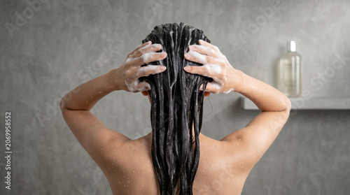 Woman washing hair bathroom shampoo foam shower hygiene