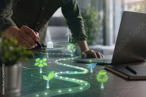 Sustainable energy planning with hand drawing glowing green path, laptop on desk, renewable power icon, business concept