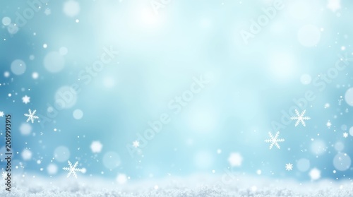 Beautiful winter background with falling snowflakes and soft blue glowing light bokeh