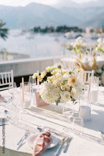Elegant wedding table with pastel floral centerpiece outdoors