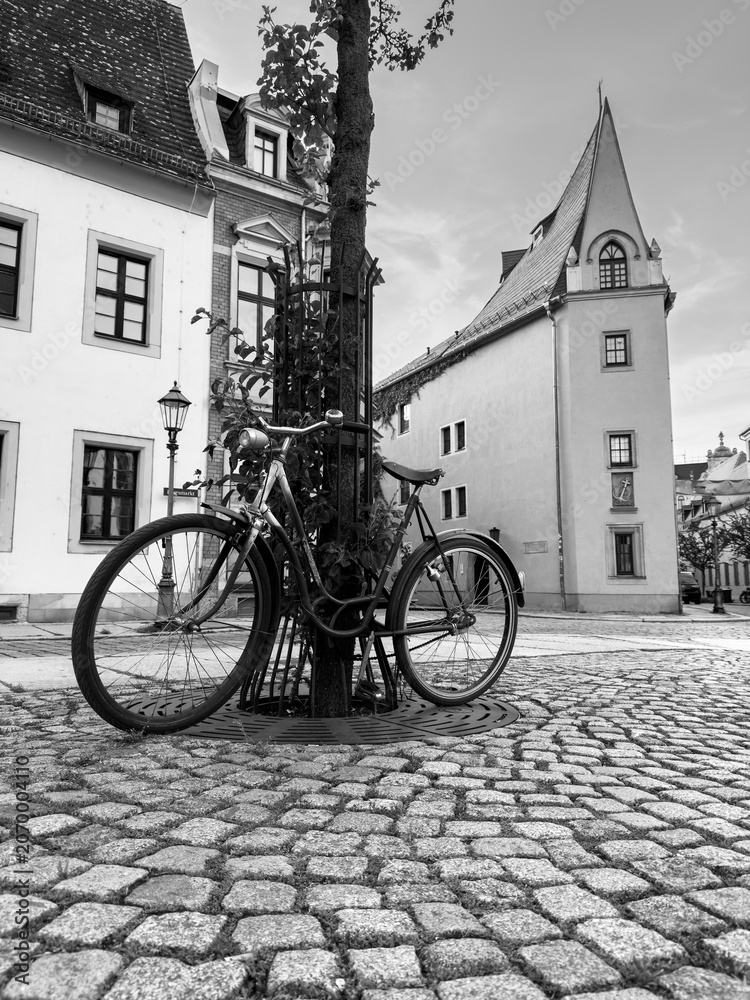 Fototapeta premium Old Bicycle on a Street in Zwickau, East Germany black and white