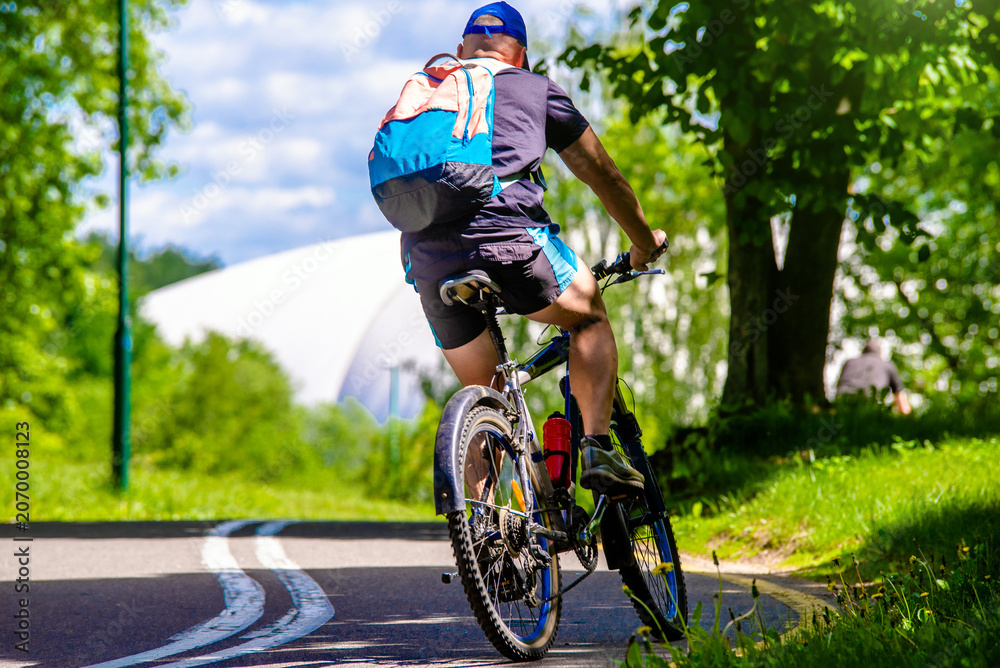 Fototapeta premium Cyclist ride on the bike path in the city Park
