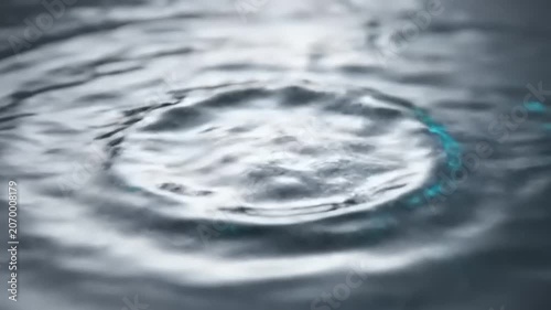 Water Droplet Creates Ripples on Surface.