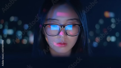 Woman wearing glasses at night city.