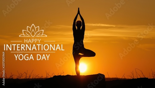 Silhouette of a person doing a yoga pose during a beautiful orange sunset