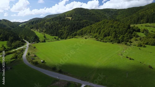 Aerial Drone View of a Scenic Road Through Forests, Meadows and Mountains near Cicmany in Slovakia
