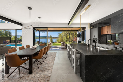 Modern luxury home kitchen with putting green, pool, and river view