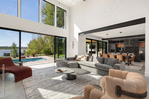 Luxury modern home living room and kitchen with pool and river view