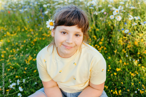 Portrait of smiling child girl in wildflower meadow