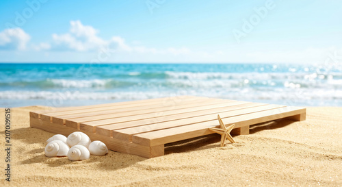 Empty wooden platform on sandy beach with starfish and seashells for summer product display mockup against sunny ocean background