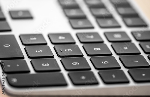 Close up selective focus shot of a black wireless computer keyboard