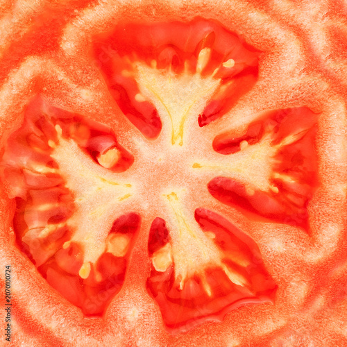 Macro slice of fresh red tomato texture background