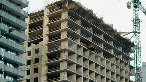 Obraz na plátne a high rise building is currently under construction, featuring an exposed concr