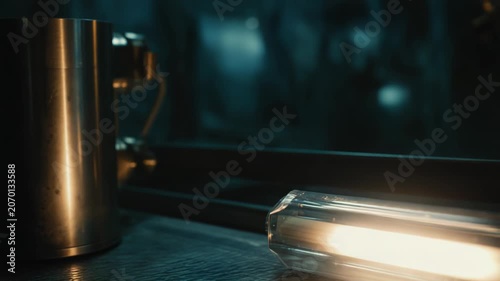 Artificial light source glowing brightly on a textured surface, creating an atmosphere of scientific research, innovation, and futuristic technology in a dimly lit laboratory setting