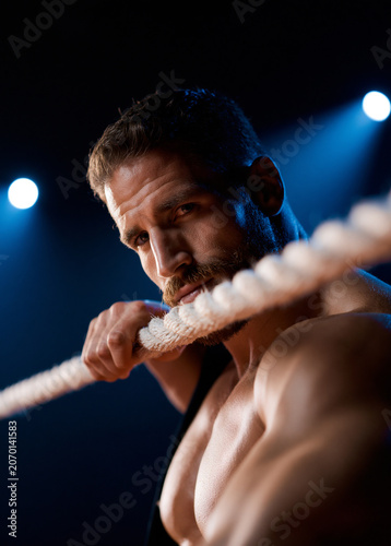 Male Boxer Leaning on Boxing Ring Rope