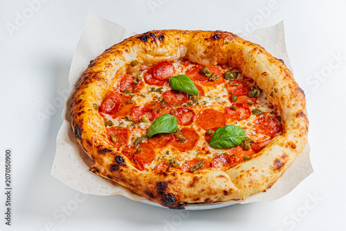 Photography Delicious pepperoni pizza topped with fresh basil sits on a plate, perfect for a