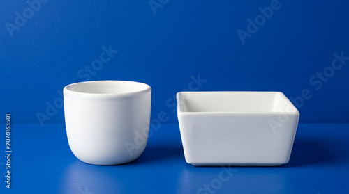 Coffee and granola bowl on a blue background with a fresh and inviting atmosphere